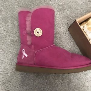 Woman’s pink Ugg breast cancer boots